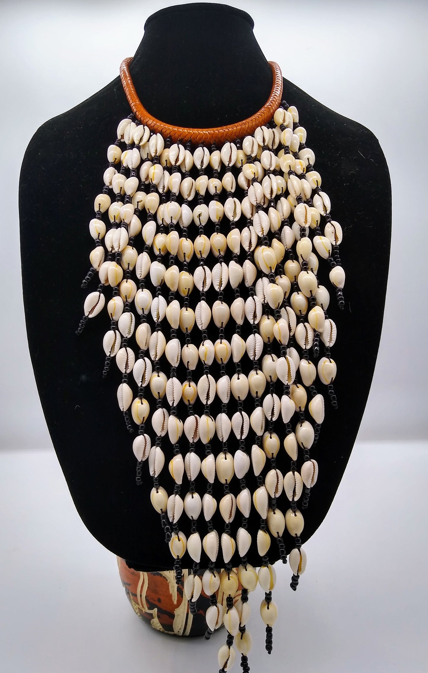Cowry shell cascade necklace with braided goat leather and mustard bead
