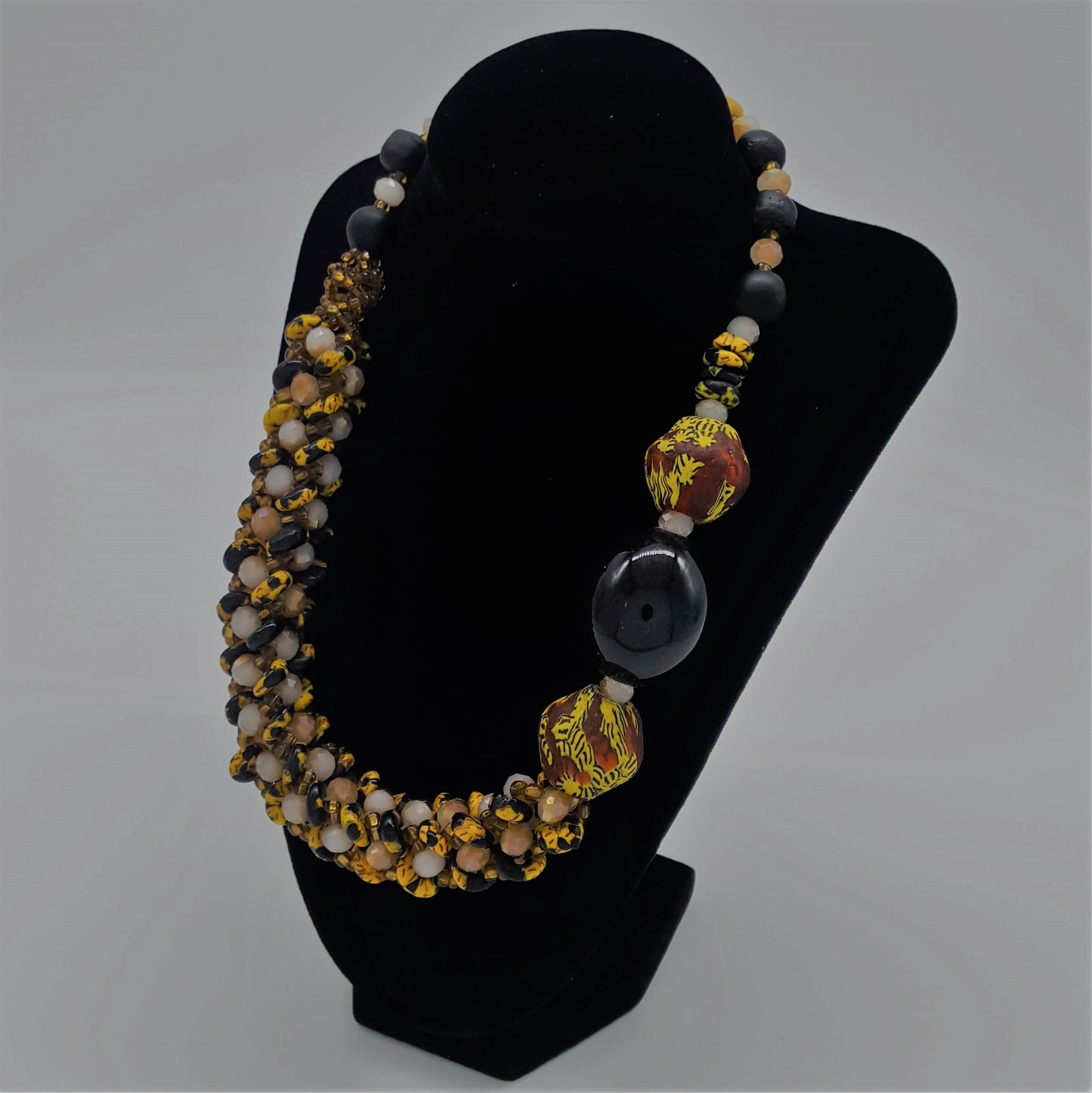 Traditional Ghana yellow glass beaded necklace, with three large colored side beads, side view