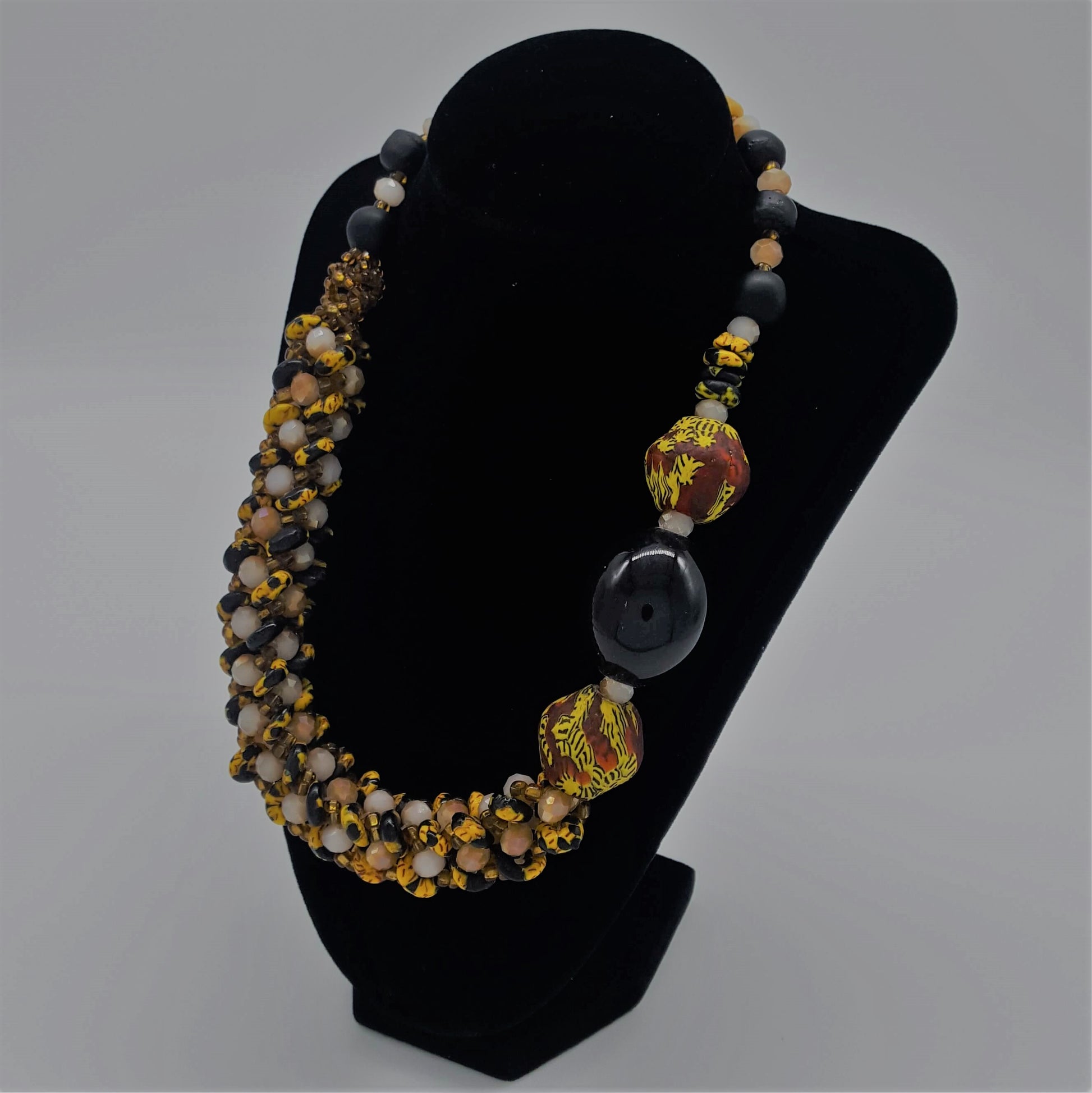 Traditional Ghana yellow glass beaded necklace, with three large colored side beads, side view