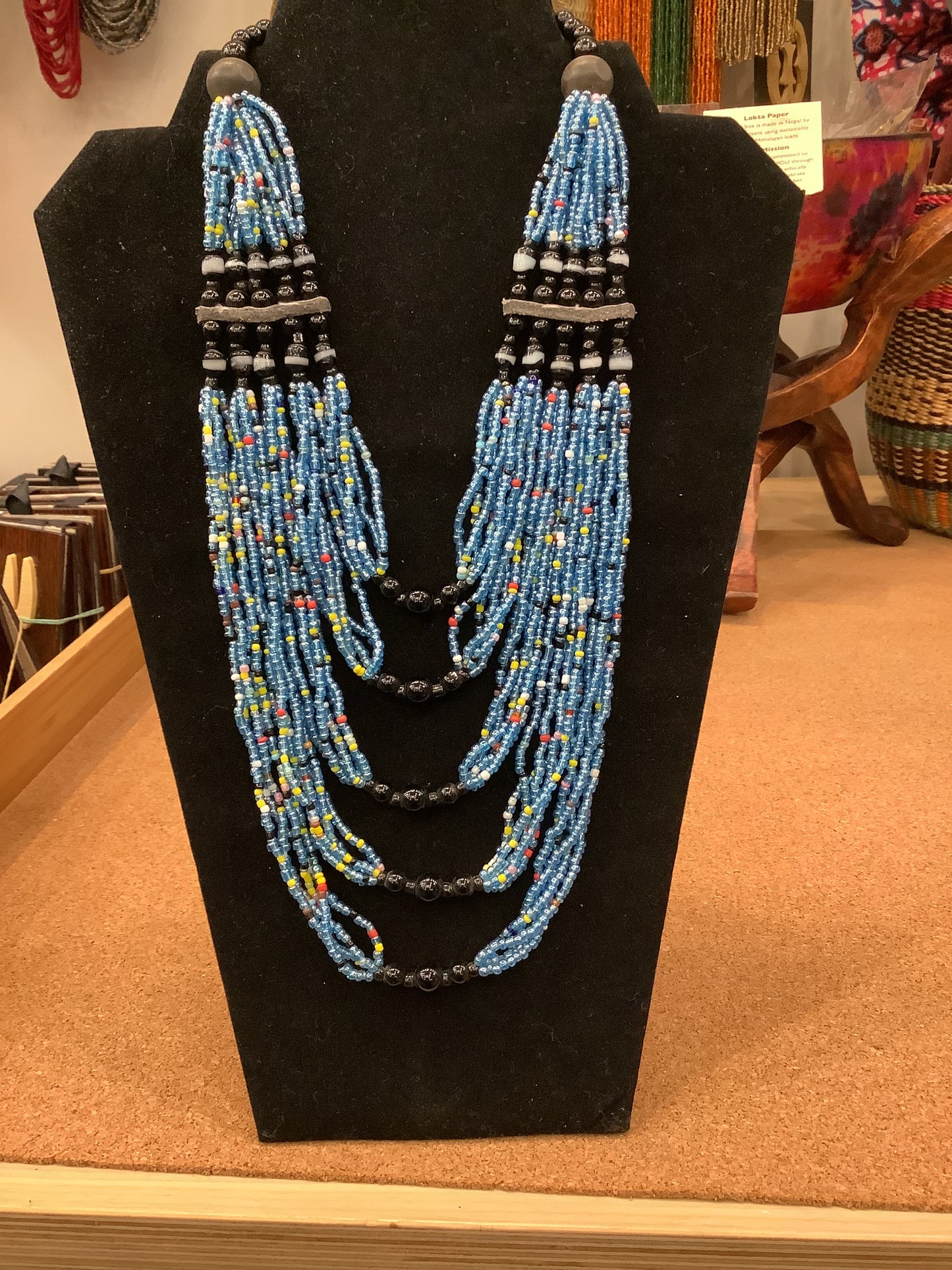 mostly blue beaded evelyn necklace, interspersed with red, white and yellow beads