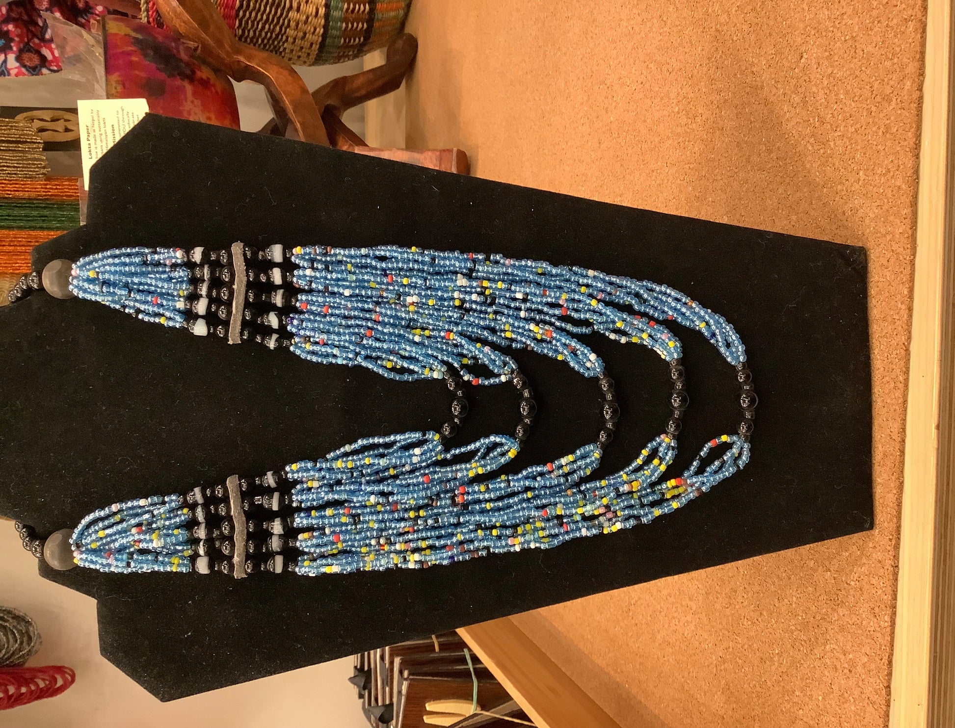 mostly blue beaded evelyn necklace, interspersed with red, white and yellow beads