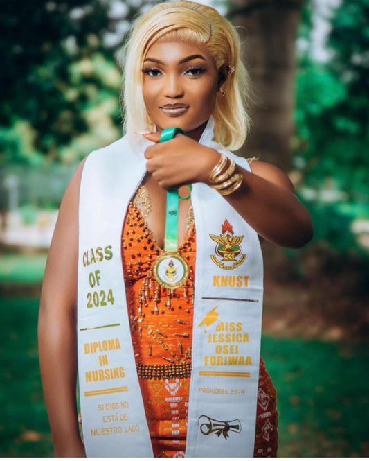 Graduate wearing a sash with 'Class of 2024' and 'KNUST' text, standing outdoors.